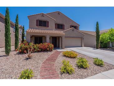 Charming two-story home with a well-maintained desert-style front yard and walkway at 5445 S 239Th Dr, Buckeye, AZ 85326