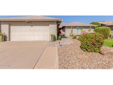 Charming home featuring desert landscaping and a paved walkway to a red front door at 10410 E San Tan Blvd, Sun Lakes, AZ 85248