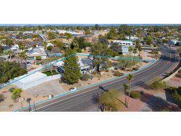 Expansive property showcasing a charming home with mature trees and desert landscaping at 12836 N 60Th St, Scottsdale, AZ 85254