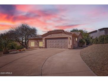 Charming single-story home featuring a spacious driveway, two-car garage, and Southwestern-style architecture at 14410 N Silverado Dr, Fountain Hills, AZ 85268