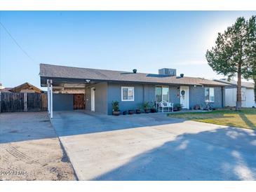 Charming single-story home with a spacious driveway, covered parking, and a well-manicured lawn at 1635 W Grovers Ave, Phoenix, AZ 85023