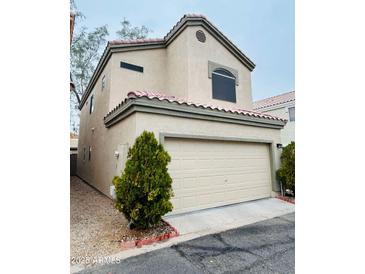 Charming two-story home featuring a two-car garage and desert landscaping, offering comfortable and stylish living at 1750 W Union Hills Dr # 91, Phoenix, AZ 85027