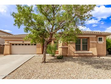 Attractive single-story home featuring a neutral-toned exterior, desert landscaping and a two car garage at 2436 W Kachina Trl, Phoenix, AZ 85041