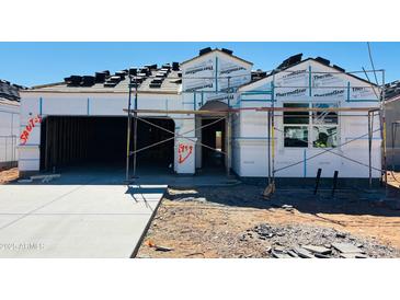 Under construction home featuring a two-car garage and a tile roof being installed at 28216 N Nealite Dr, San Tan Valley, AZ 85143