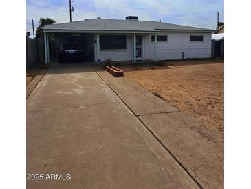 Charming single-story home with a covered carport and a well-maintained front yard at 3321 E Culver St, Phoenix, AZ 85008