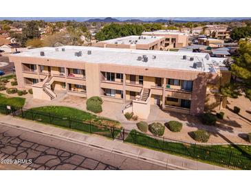 Attractive apartment building with private balconies and well-maintained landscaping, complemented by distant mountain views at 3601 W Tierra Buena Ln # 233, Phoenix, AZ 85053