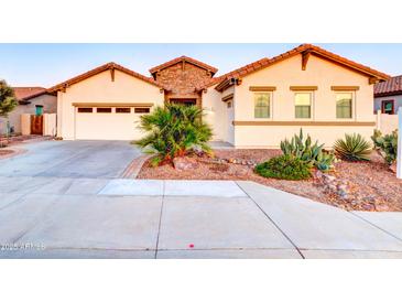 Charming single-story home with a three-car garage, desert landscaping, and a stone accent entry at 4545 S Ellesmere St, Gilbert, AZ 85297