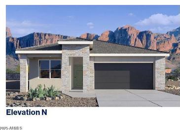 Beautiful single-Gathering home featuring a two-car garage, a modern entrance, and desert landscaping at 5008 S 105Th Ln, Tolleson, AZ 85353