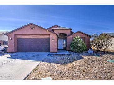 Charming single-story home with a well-maintained front yard and attached two-car garage at 5071 W Warren Dr, Casa Grande, AZ 85194