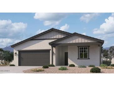 Beautiful single-story home with neutral stucco, dark gray trim, and a two-car garage at 5583 S 240Th Ln, Buckeye, AZ 85326