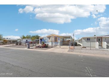 Charming single-story home with a covered carport and a fenced yard perfect for outdoor living at 690 S 92Nd Pl, Mesa, AZ 85208