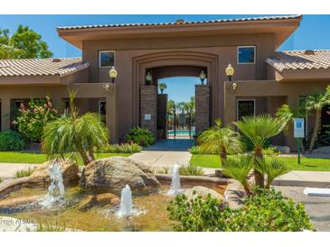 Welcoming entrance to the community, featuring a water fountain, mature landscaping and glimpses of the pool at 7009 E Acoma Dr # 1046, Scottsdale, AZ 85254