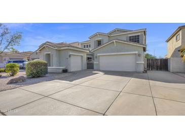 Exterior view of a home featuring an extended driveway and a two-car garage at 10343 E Jacob Ave, Mesa, AZ 85209