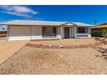 Charming single-story home featuring a xeriscaped front yard, attached garage, and covered entryway at 10846 W Sun City Blvd, Sun City, AZ 85351