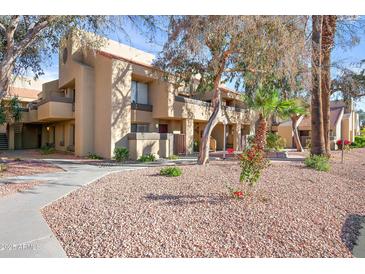 Inviting condo exterior featuring manicured landscaping and pathways to each unit at 1432 W Emerald Ave # 742, Mesa, AZ 85202