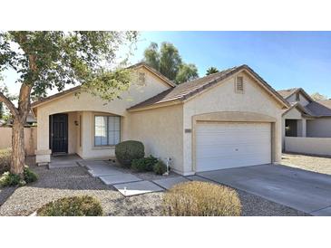 Charming single-story home features a well-maintained yard with a two car garage and a covered front entryway at 2541 S Sunnyvale Ave, Gilbert, AZ 85295