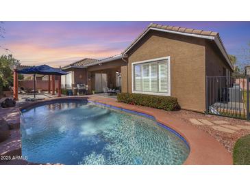 Relaxing backyard pool with a pergola, BBQ, and patio furniture, perfect for outdoor entertaining at 2571 E Balsam Ct, Chandler, AZ 85286