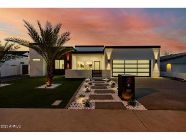 Stunning modern home with a well-manicured lawn and pathway leading to the front door at dusk at 2642 N Fiesta St, Scottsdale, AZ 85257