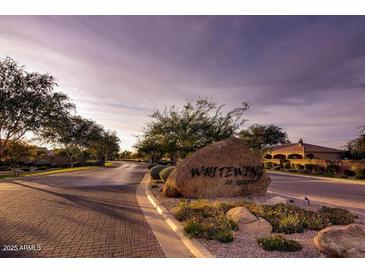 Welcoming entrance to Whitewing featuring lush landscaping and stone signage at 2879 E Portola Valley Ct, Gilbert, AZ 85297