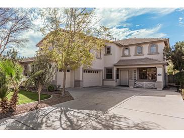 Stately two-story home with a three-car garage and inviting curb appeal on a sunny day at 337 E Clairidge Dr, San Tan Valley, AZ 85143