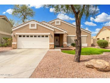 Charming single-story home featuring a well-maintained front yard and neutral color palette at 39242 N Luke Cir, San Tan Valley, AZ 85140