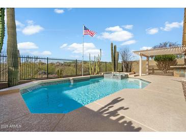 Refreshing pool with a tanning ledge, desert landscaping, and a pergola in a private backyard at 40504 N Territory Trl, Anthem, AZ 85086