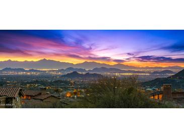 Expansive city views from a luxurious home, showcasing vibrant sunset and mountain views at 42237 N 107Th Pl, Scottsdale, AZ 85262