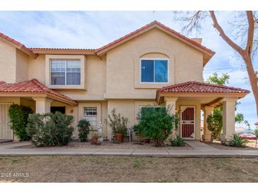 Charming two-story townhouse with a red tile roof and well-maintained front yard at 5808 E Brown Rd # 110, Mesa, AZ 85205