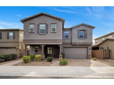 Two-story gray house with gray shutters, well-maintained landscaping, and a two-car garage at 7057 E Diamond St, Scottsdale, AZ 85257