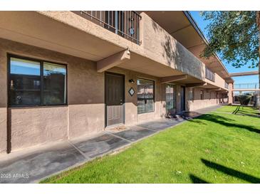 Inviting two-story condo building with well-maintained landscaping and private entryways at 7110 E Continental Dr # 1031, Scottsdale, AZ 85257