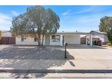 Charming single-story home with carport, xeriscaped front yard, and beautiful shade tree at 739 E Glade Ave, Mesa, AZ 85204