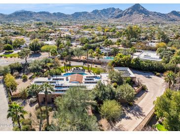 Expansive property featuring a pool and lush landscaping with views of the surrounding city and mountains at 8008 N 66Th St, Paradise Valley, AZ 85253