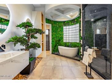 Modern bathroom showcasing a unique soaking tub, artistic vanity, and decorative moss wall at 815 E County Down Dr, Chandler, AZ 85249