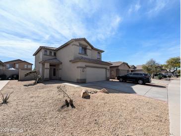 Two-story home with a xeriscaped front yard and attached two-car garage at 8861 W Paradise Dr, Peoria, AZ 85345