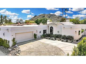 Stunning home featuring a two-car garage, desert landscaping, and mountain views at 9430 N 25Th St, Phoenix, AZ 85028