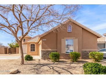 Charming single-Gathering home featuring a low maintenance desert landscape, quaint architectural details, and a cozy design at 12312 N 147Th Ln, Surprise, AZ 85379