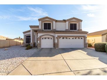 Two-story home featuring a three-car garage, neutral color palette, and low-maintenance desert landscaping at 12809 W Evans Dr, El Mirage, AZ 85335