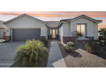 Beautiful single-story home with a well-manicured lawn, desert landscaping, and inviting entryway at 14325 W Faye Way, Surprise, AZ 85387