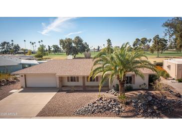 Charming single-story home boasting desert landscaping, attached garage, and a well-manicured front yard at 15602 N Nicklaus Ln, Sun City, AZ 85351