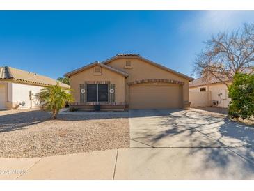 Charming single-story home with a neutral color palette, well-maintained landscape, and attached two car garage at 1847 E Milky Way, Gilbert, AZ 85295