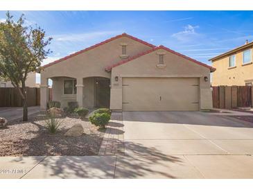 Charming single-story home featuring a two-car garage, low maintenance landscaping, and a welcoming entryway at 18637 W Fulton St, Goodyear, AZ 85338