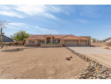 Charming single-story home with a red tile roof and a three-car garage at 205 E Irvine Rd, Phoenix, AZ 85086