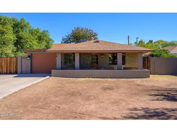 Charming single-story home with a welcoming front porch and a well-maintained yard at 2217 N 37Th Pl, Phoenix, AZ 85008