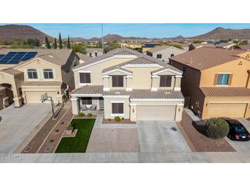 Charming two-story home featuring neutral stucco, landscaped front yard, and an attached two-car garage at 23510 N 25Th St, Phoenix, AZ 85024