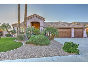 Charming single-story home boasting a three-car garage, desert landscaping, and a tile roof at 24024 N 74Th St, Scottsdale, AZ 85255