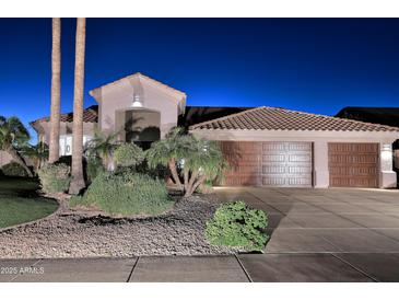 Charming single-story home boasting a three-car garage, desert landscaping, and a tile roof at 24024 N 74Th St, Scottsdale, AZ 85255