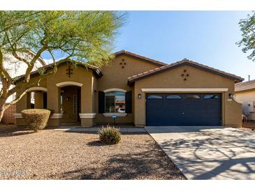 Charming single-story home featuring a well-maintained landscape and a two-car garage at 3233 N 137Th Dr, Avondale, AZ 85392