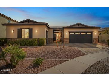 Charming single-story home with a desert landscape, a two car garage and stone accents at 3793 E Canyon Pl, Chandler, AZ 85249