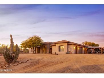 Charming desert home featuring a well-manicured landscape and a desert cactus at 39610 N 12Th St, Phoenix, AZ 85086