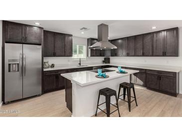 Stunning kitchen featuring dark cabinets, stainless steel appliances, and a center island with bar seating at 42 E 14Th St, Mesa, AZ 85201